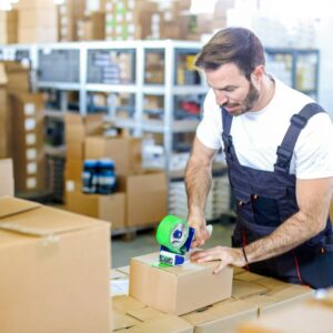 Man taping boxes for storage