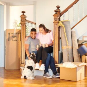 Couple taking break with dog moving home
