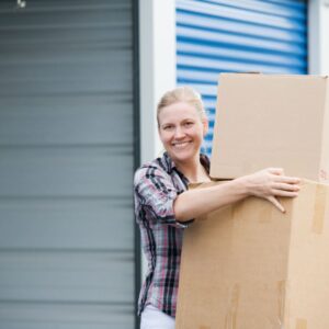 Woman carrying boxes to storage unit